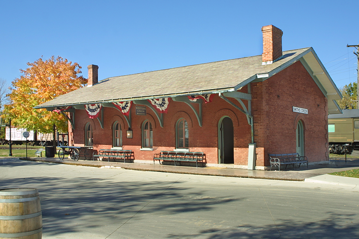 Smiths Creek Depot Small brick building with arched windows and decorative eaves and bunting