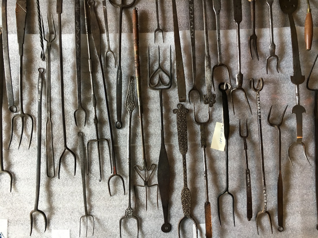 A group of long metal implements lay on a table