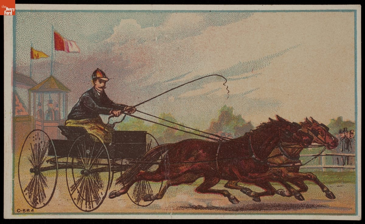 Man in open cart harnessed to two horses, running on track with spectators watching