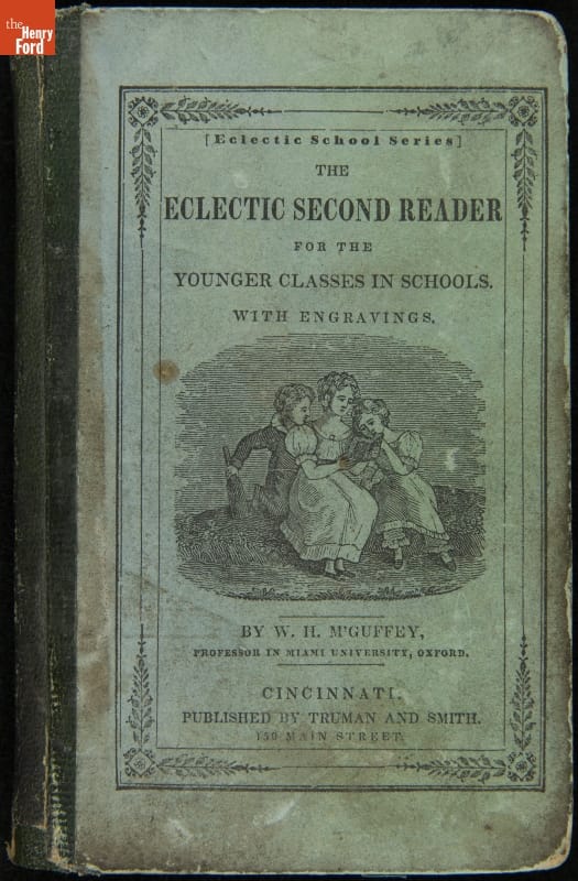 Blue book cover with image of three people reading a book; also contains text