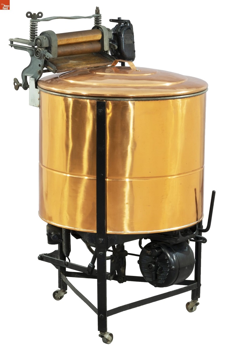 Machine on stand with large copper tub and motor below