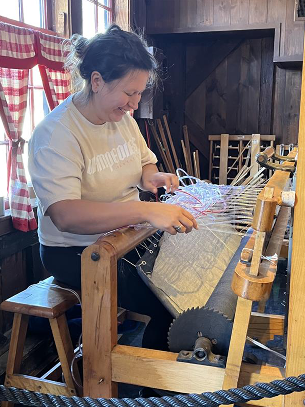 Maggie Thompson weaving on a loom