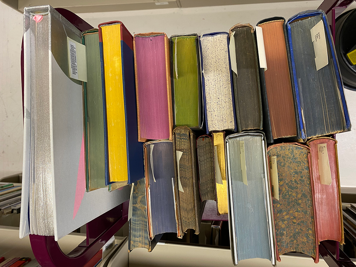 several books stacked, with colorful pages